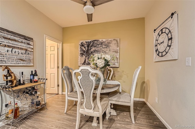 dining room with hardwood / wood-style floors and ceiling fan