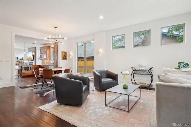 1511 S Pennsylvania St, Denver, CO 80210 - living room with wood-type flooring, a chandelier, baseboards, and recessed lighting