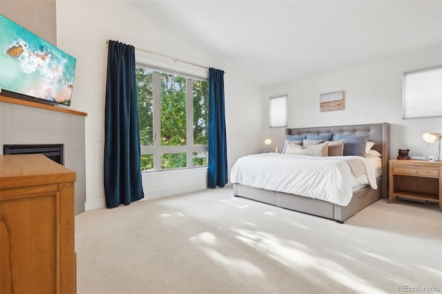 1511 S Pennsylvania St, Denver, CO 80210 - bedroom featuring vaulted ceiling, carpet floors, and a tile fireplace
