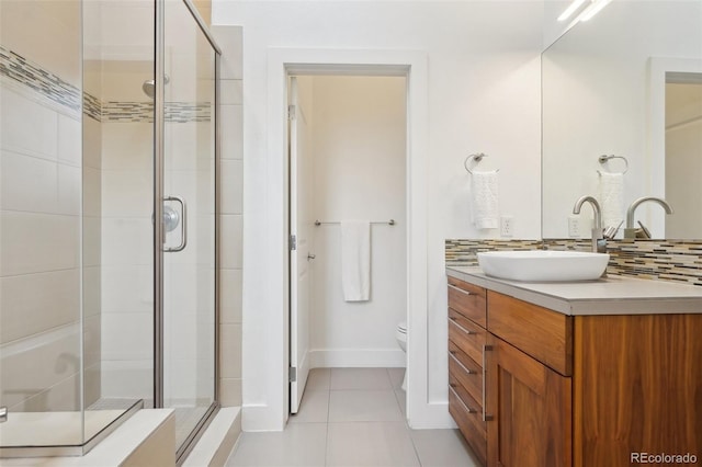 1511 S Pennsylvania St, Denver, CO 80210 - full bath featuring a stall shower, toilet, vanity, tile patterned flooring, and tasteful backsplash