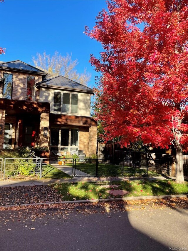 1511 S Pennsylvania St, Denver, CO 80210 - view of front of house featuring a standing seam roof, a fenced front yard, metal roof, and a gate