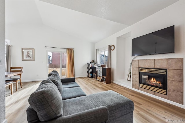 living room featuring wood finished floors, a fireplace, and baseboards