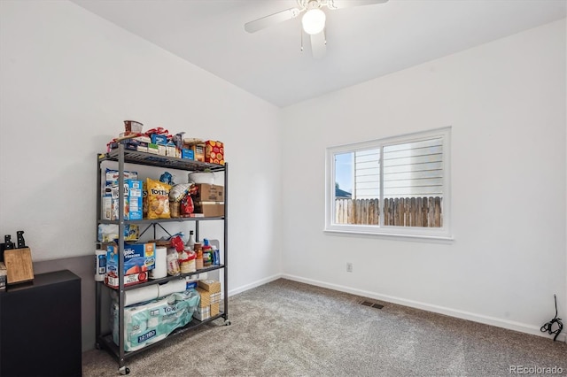 interior space featuring baseboards, visible vents, carpet floors, and ceiling fan