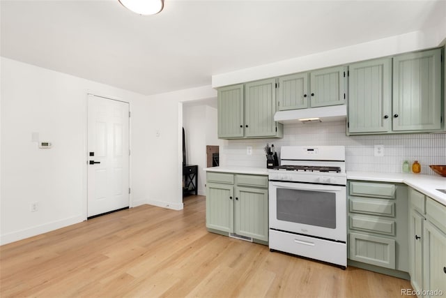 kitchen featuring green cabinetry, light hardwood / wood-style floors, and gas range gas stove