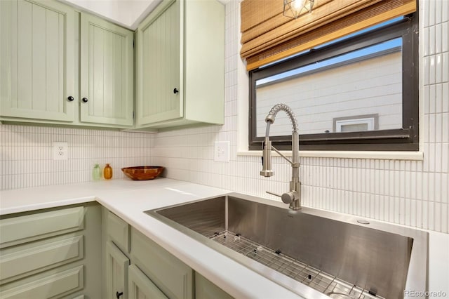 kitchen with sink, green cabinets, and tasteful backsplash