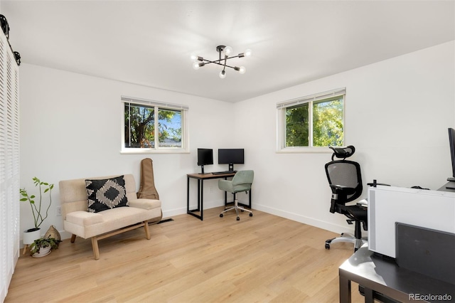 office area with a notable chandelier, light hardwood / wood-style floors, and plenty of natural light