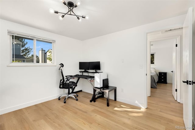 office area with a notable chandelier and light hardwood / wood-style floors