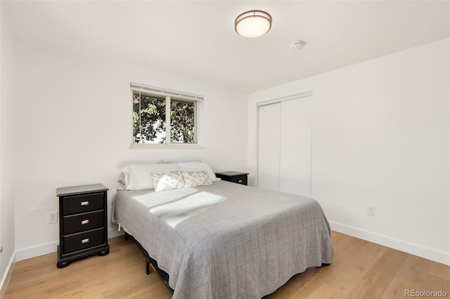 bedroom with a closet and light hardwood / wood-style floors