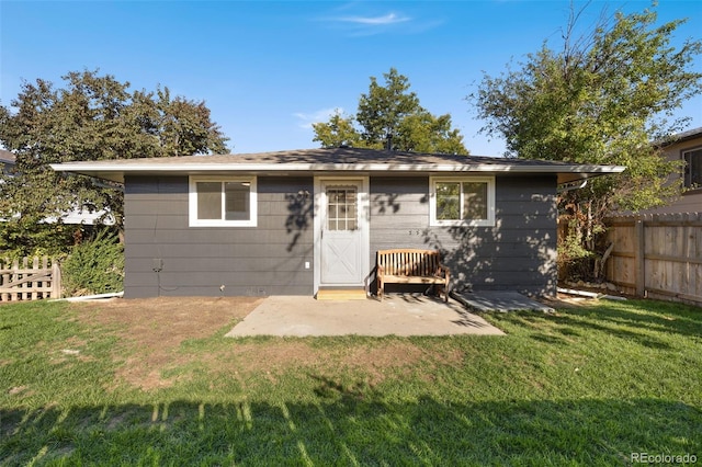 back of house with a lawn