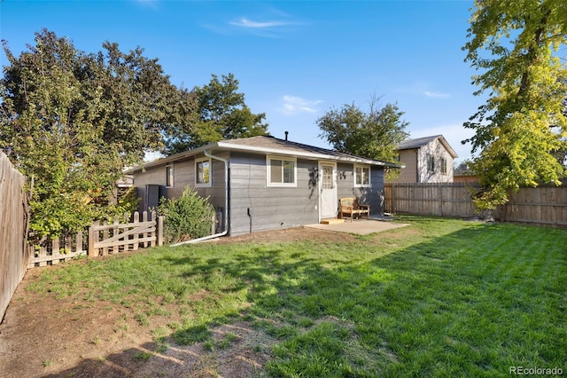 rear view of house with a yard and a patio area