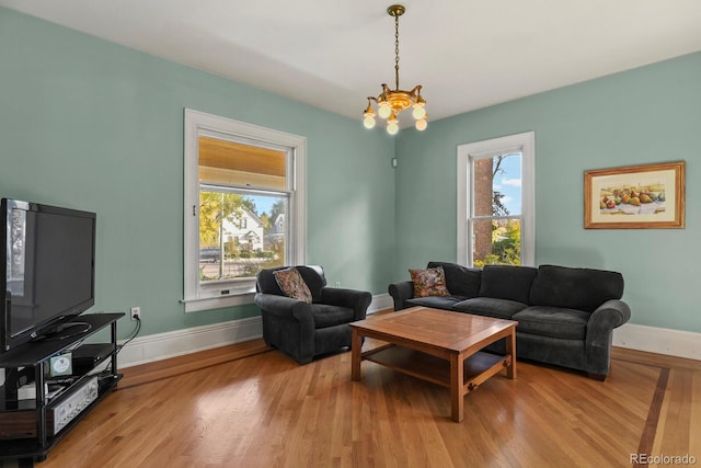 living room featuring light hardwood / wood-style floors, a chandelier, and plenty of natural light