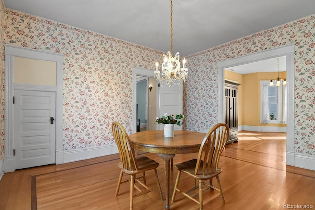 dining space featuring a notable chandelier and light hardwood / wood-style floors