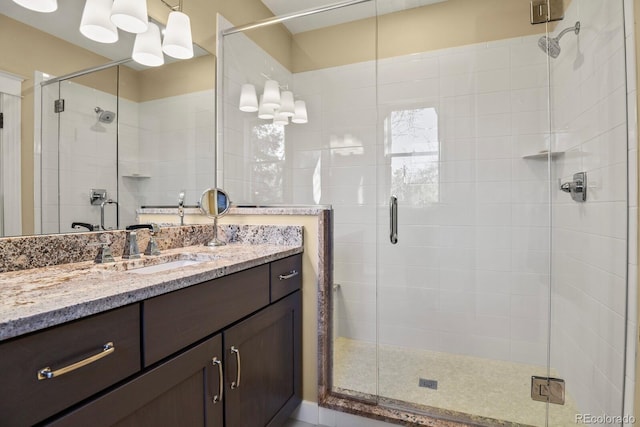 bathroom with vanity and a shower with shower door