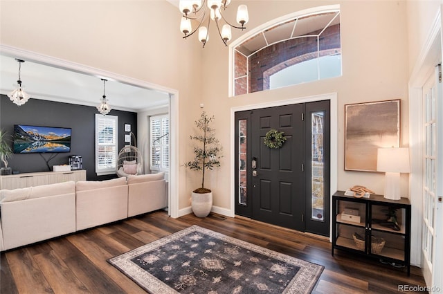 entrance foyer featuring an inviting chandelier, dark hardwood / wood-style flooring, and a high ceiling