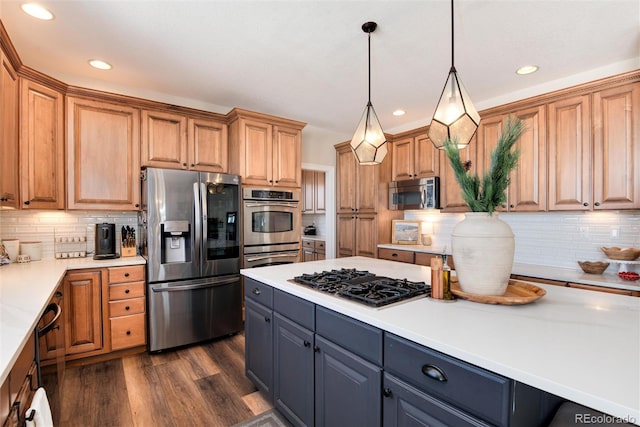 kitchen with gray cabinetry, tasteful backsplash, hanging light fixtures, dark hardwood / wood-style floors, and stainless steel appliances