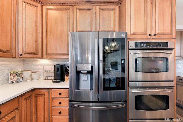 kitchen with stainless steel appliances and decorative backsplash