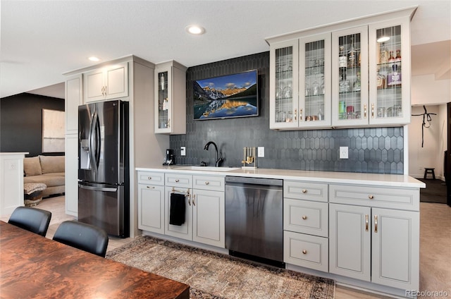 kitchen featuring stainless steel appliances, tasteful backsplash, and sink