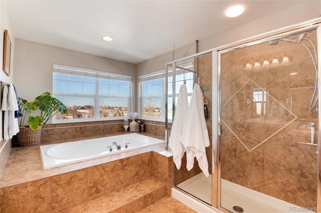 bathroom featuring shower with separate bathtub