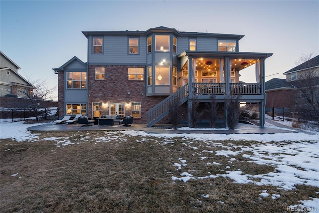 snow covered house featuring outdoor lounge area