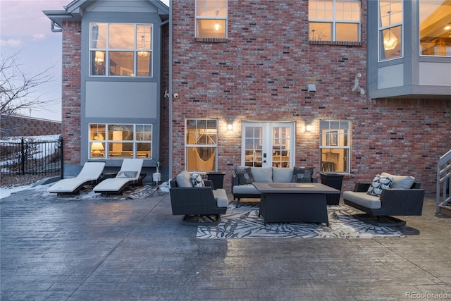 back house at dusk featuring an outdoor hangout area and a patio area