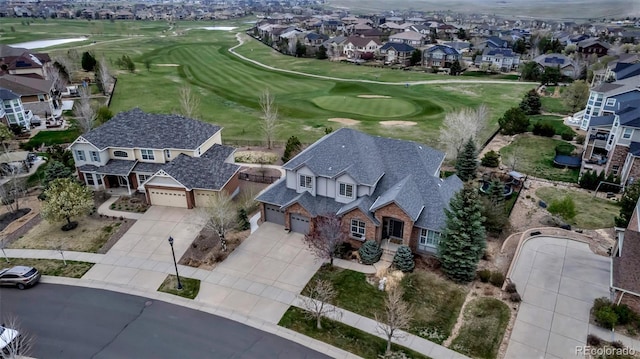 birds eye view of property with view of golf course and a residential view