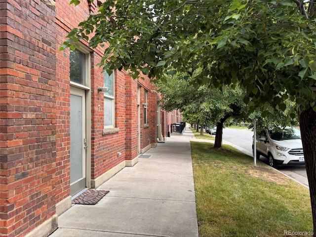 1111 Osage St Unit 7, Denver, CO 80204 - view of side of home featuring brick siding and a lawn