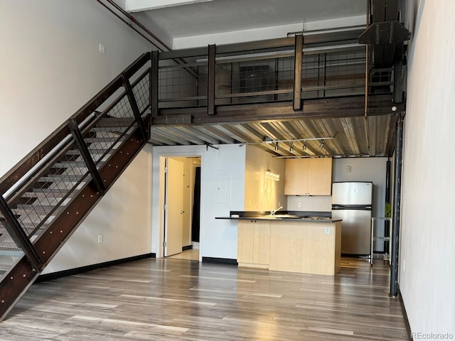 1111 Osage St Unit 7, Denver, CO 80204 - kitchen featuring freestanding refrigerator, dark countertops, wood finished floors, and a peninsula