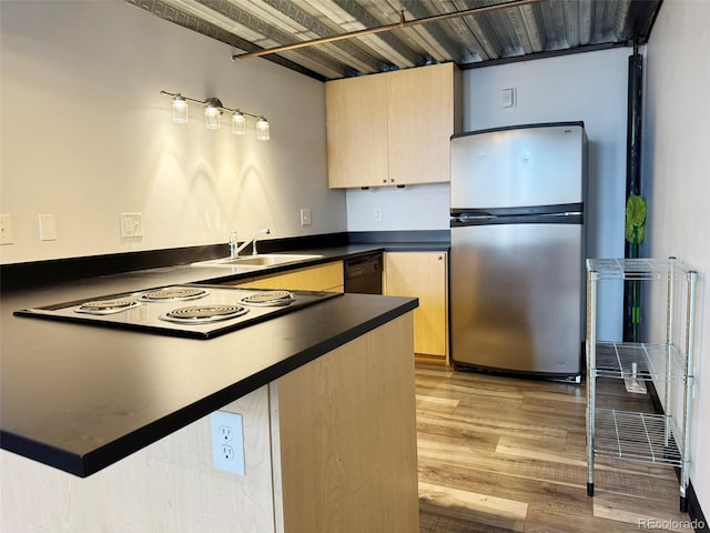 1111 Osage St Unit 7, Denver, CO 80204 - kitchen with freestanding refrigerator, light brown cabinetry, dark countertops, a peninsula, and dishwasher