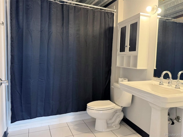 1111 Osage St Unit 7, Denver, CO 80204 - bathroom with toilet, tile patterned floors, a shower with curtain, and baseboards