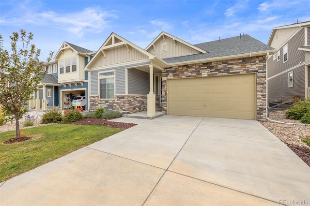 craftsman-style home with a garage and a front yard