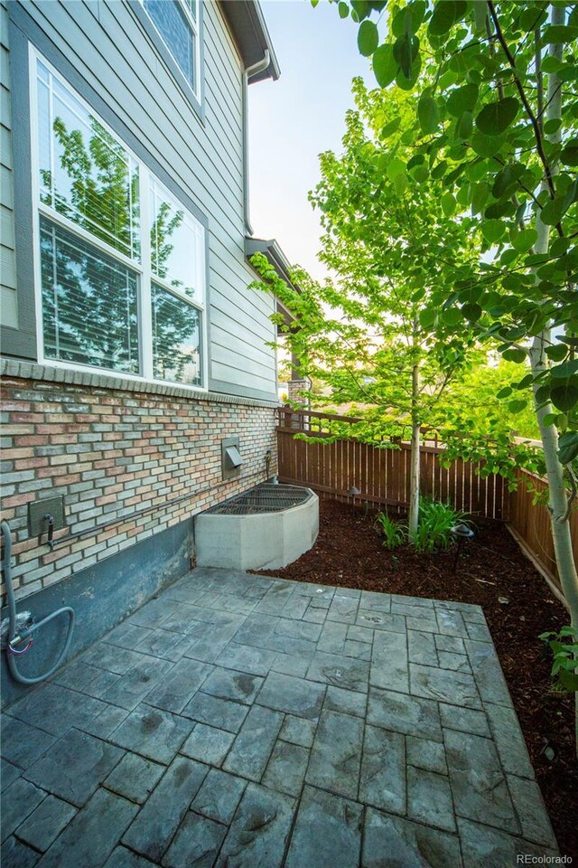 359 Courtfield Way, Castle Pines, CO 80108 - fenced backyard featuring a patio area