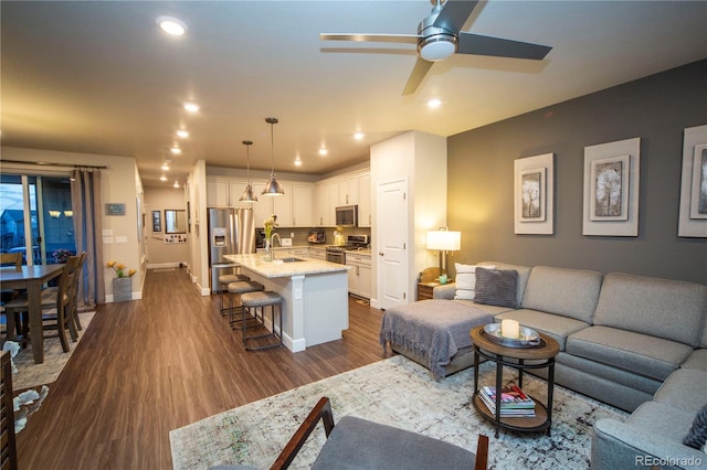 359 Courtfield Way, Castle Pines, CO 80108 - living room featuring dark wood finished floors, baseboards, a ceiling fan, and recessed lighting