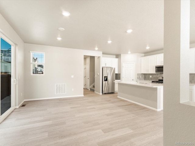 interior space with sink and light wood-type flooring