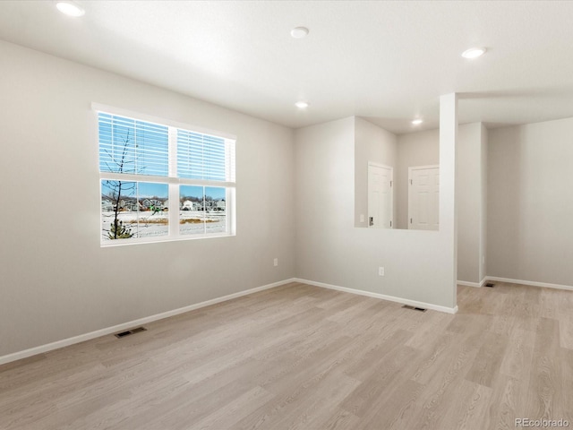 spare room featuring light hardwood / wood-style flooring