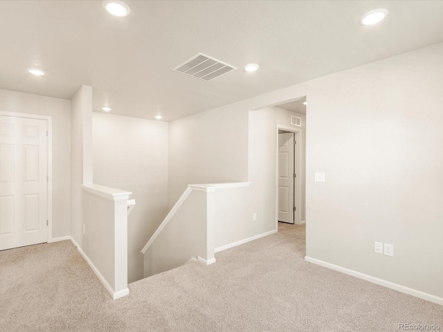 hall featuring light colored carpet