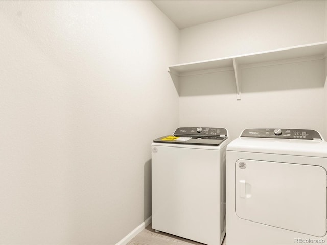 laundry room featuring washing machine and clothes dryer