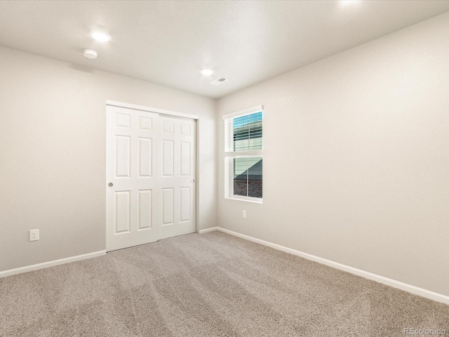 unfurnished bedroom featuring a closet and carpet flooring