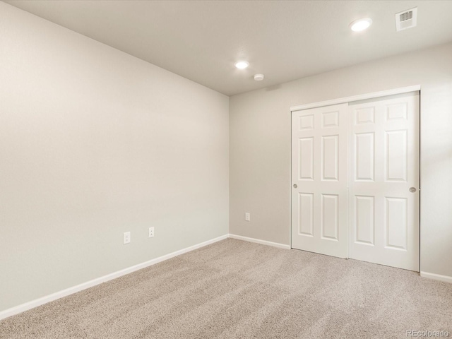 unfurnished bedroom featuring carpet floors and a closet