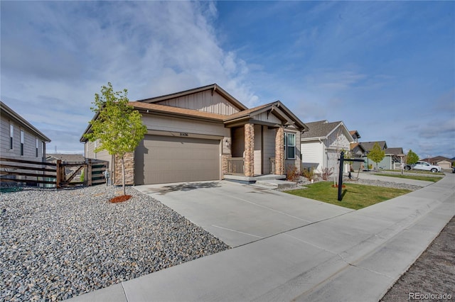 21436 E Stanford Ave, Aurora, CO 80015 - ranch-style home featuring board and batten siding, fence, concrete driveway, an attached garage, and stone siding