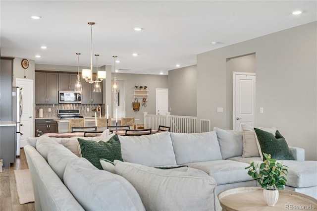 21436 E Stanford Ave, Aurora, CO 80015 - living area with a chandelier, recessed lighting, light wood-style flooring, and visible vents