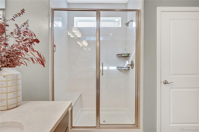 21436 E Stanford Ave, Aurora, CO 80015 - full bath featuring vanity, a textured wall, and a stall shower