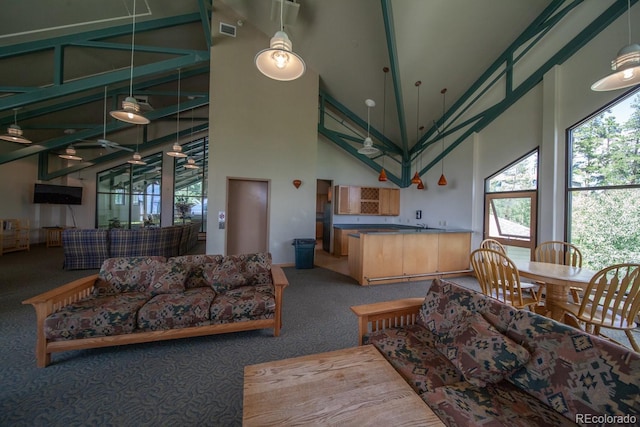 8500 Ryan Gulch Rd Unit 101, Silverthorne, CO 80498 - living area with carpet flooring, high vaulted ceiling, and baseboards