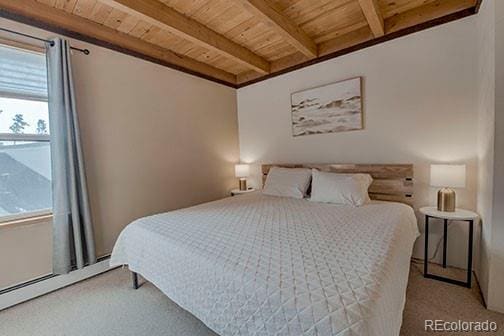 8500 Ryan Gulch Rd Unit 101, Silverthorne, CO 80498 - carpeted bedroom with wooden ceiling, beam ceiling, multiple windows, and a baseboard heating unit