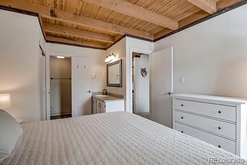 8500 Ryan Gulch Rd Unit 101, Silverthorne, CO 80498 - bedroom with wooden ceiling, beam ceiling, and a sink