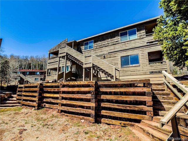 back of house featuring stairs