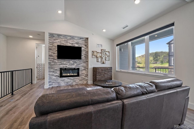 31191 Black Eagle Dr Unit 304, Evergreen, CO 80439 - living room with vaulted ceiling, wood finished floors, a glass covered fireplace, and recessed lighting