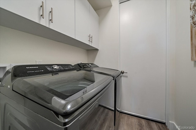 31191 Black Eagle Dr Unit 304, Evergreen, CO 80439 - laundry area featuring cabinet space, separate washer and dryer, and dark wood-style flooring