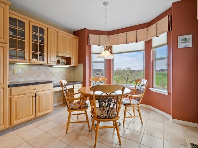 dining area with baseboards and light tile patterned floors