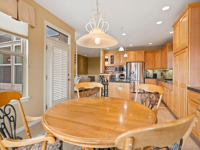 dining space with recessed lighting, baseboards, and light tile patterned floors