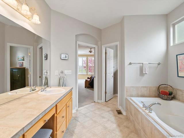 full bathroom featuring a garden tub, tile patterned flooring, visible vents, vanity, and ensuite bath